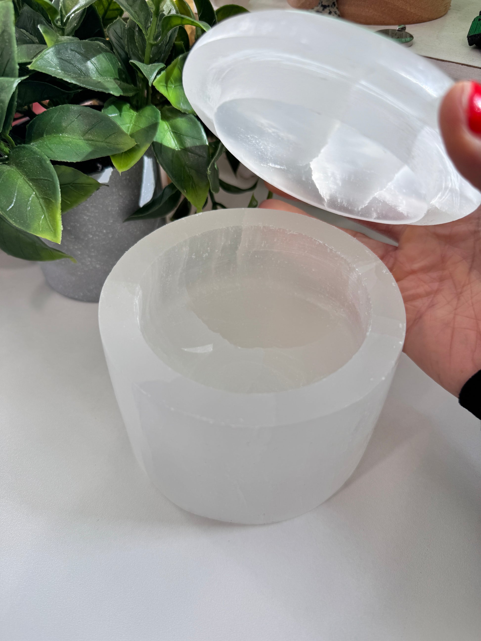 A luminous selenite dish with a matching lid, crafted to charge crystal bracelets, store sacred items, and become a treasured keepsake over time. Bracelets not included.