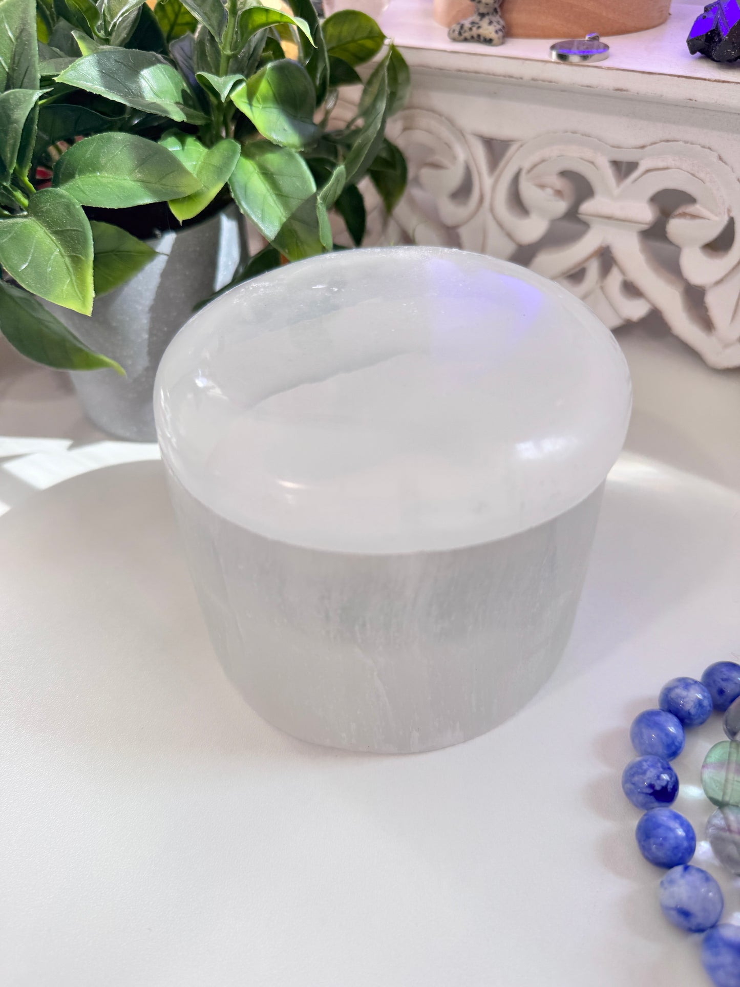 A luminous selenite dish with a matching lid, crafted to charge crystal bracelets, store sacred items, and become a treasured keepsake over time. Bracelets not included.