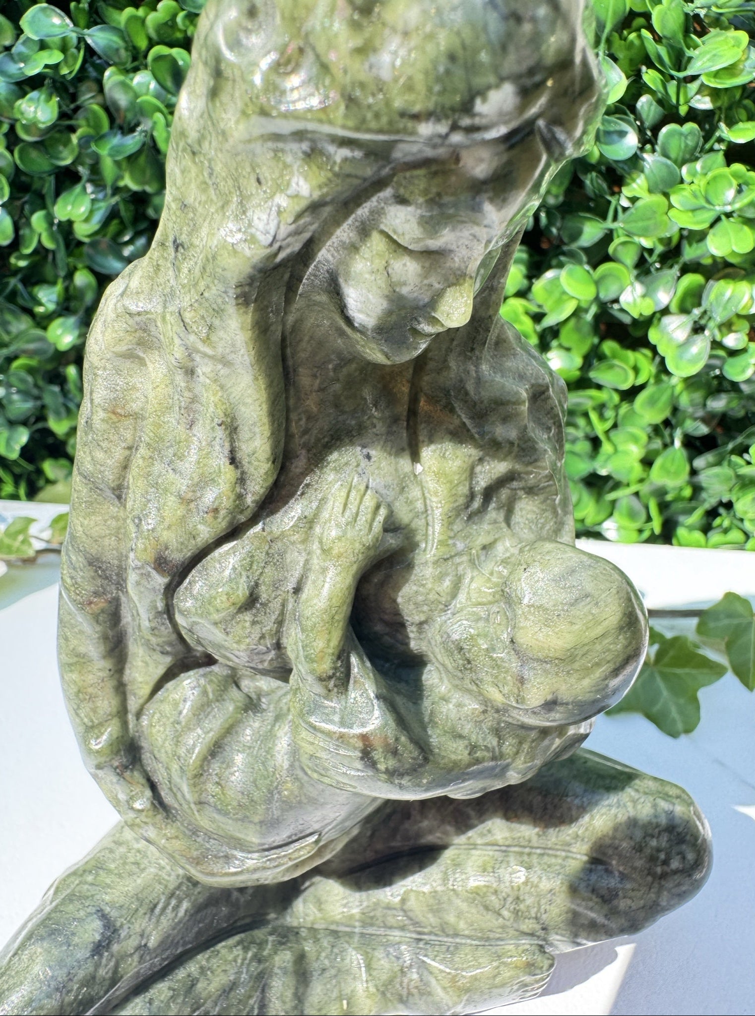 Jade carving, close up of breastfeeding mother and child
